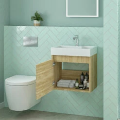 Minnie 500mm Wall Mounted 1 Door Vanity Unit & Polymarble Basin - Natural Oak -TAP WAREHOUSE Shop drench minnie natural oak 500mm wall hung unit internal lifestyle