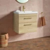 Emily 600mm Natural Oak Wall Mounted 2 Drawer Vanity Unit, Thin-Edged Basin, Brushed Brass Handles & Overflow 2 Emily 600mm Natural Oak Wall Mounted 2 Drawer Vanity Unit, Thin-Edged Basin, Brushed Brass Handles & Overflow -TAP WAREHOUSE Shop emily oak 2draw 600 wall brass handles lifestyle